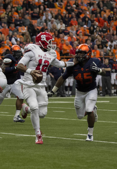 Brissett stiff-arms Franklin, who is in pursuit of a sack.