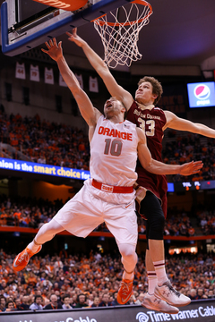 Cooney soars for a layup while Heckmann goes for a block. 