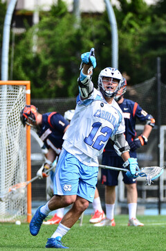 Tutton points to the crowd after scoring one of his three goals.