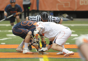 Chris Daddio faces off against Virginia faceoff specialist Mick Parks. The Cavaliers won 16 of the game's 21 faceoffs.