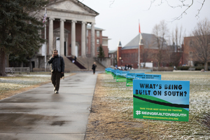 Signs line the Quad walkways offering clues about a South Campus construction project expected to be revealed in the coming weeks.