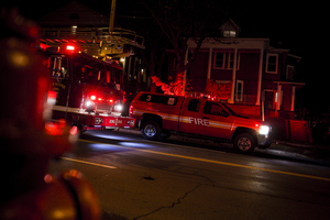 Fire trucks and Department of Public Safety vehicles line Comstock Avenue outside of the Tau Kappa Epsilon house Friday night. The fraternity's  Halloween party was shut down and evacuated due to an incident involving pepper spray. 