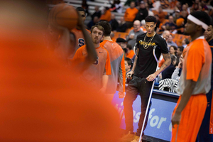 SU freshman Chris McCullough (right) watches his Orange teammates warm up before facing Wake Forest on Tuesday.