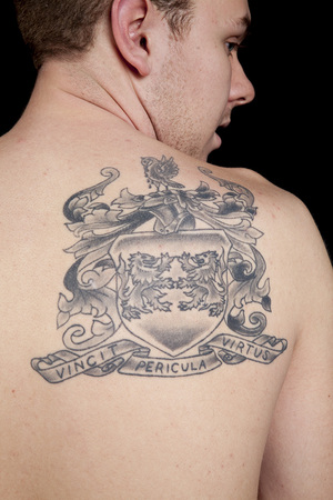 Daniel Collins got a tattoo based on his family’s coat of arms to honor his Irish heritage. The Latin words “vincit pericula virtus” translate to “virtue conquers danger.”      