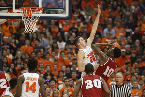 Tyler Lydon leaps to block a Nigel Hayes shot attempt in the Carrier Dome on Wednesday night. Lydon in the Orange were outrebounded by 26 rebounds. 