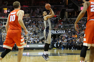 Trevor Cooney (left) and Tyler Roberson look on during Syracuse's seven-point loss to the Hoyas on Saturday afternoon.