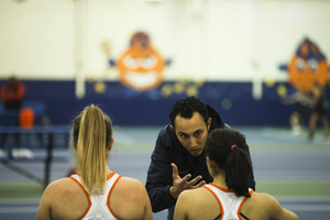 Gabriela Knutson (left) and Miranda Ramirez (right), pictured last season, conference with head coach Younes Limam. Ramirez sat out for rest while Knutson helped SU dominate.