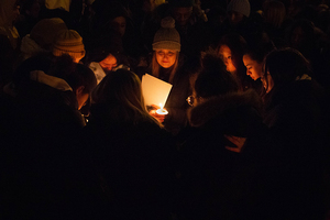 Kelly McKeon (center) and other students hold a prayer for Brianna Herrera at the vigil. McKeon was her roommate.  