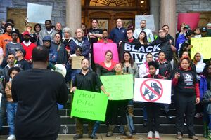 Nitch Jones (left), a local activist, said the protest was silent because people are hurt, not angry. 