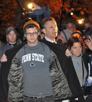 Kevin Johansen, senior integrative arts major, blocks ESPN reporter Mark Schwarz from going further up the Paternos' driveway after Sue told those who had gathered there that Joe would be coming out shortly. Johansen led several other students in blocking video cameras to get revenge. 