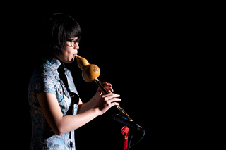 Shiyun Liu plays the Hulusi in an event for the mid-Autumn moon festival.