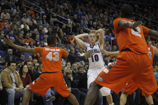 James Southerland (left) and Baye Moussa Keita (right) extend their hands in SU's 2-3 zone, freezing Kyle Smyth on the wing.