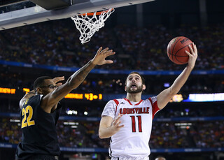 Luke Hancock attempts a layup around a Wichita State defender.