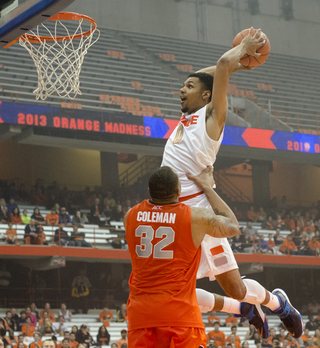 Michael Gbinije takes a little help from DaJuan Coleman en route to his slam-dunk contest victory.