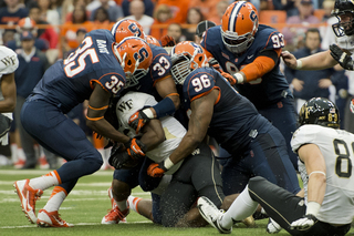 Jay Bromley and Co. swarm a Wake Forest player in the second half. The SU defense held the Demon Deacons scoreless on Saturday. 