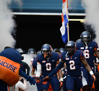 Cornerback Wayne Morgan leads Syracuse onto the field for its annual Spring Game.