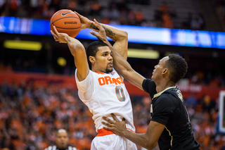 Michael Gbinije evades the defense of a WFU player while protecting the ball. The SU forward only had one point in the first half.