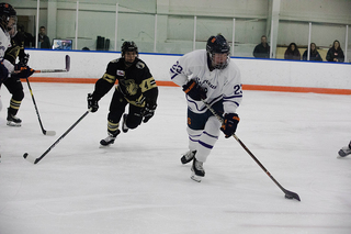 Trying to outsmart the defense, Digirolamo, No. 22, pushed the puck across the ice for her team.